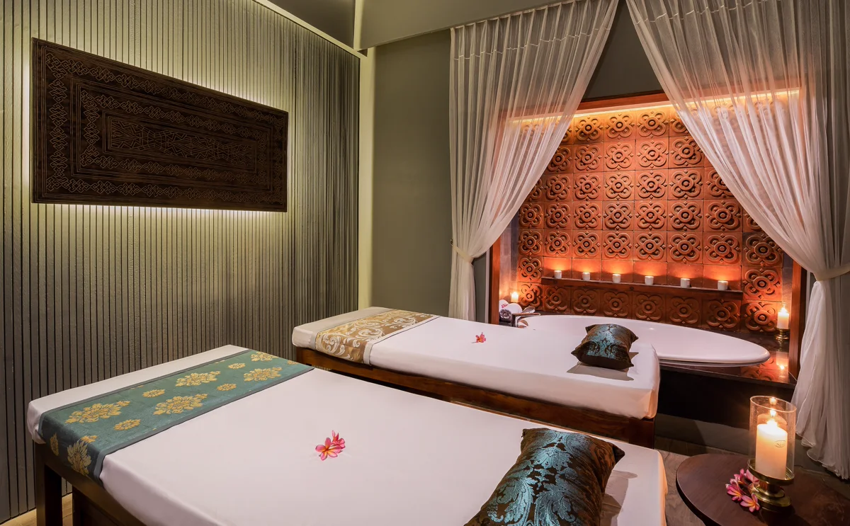 Treatment beds and carved wood details inside Sundancer Spa